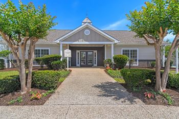 the front of a house with a walkway and treesat The Pointe Apartment Homes, Gautier, 39553